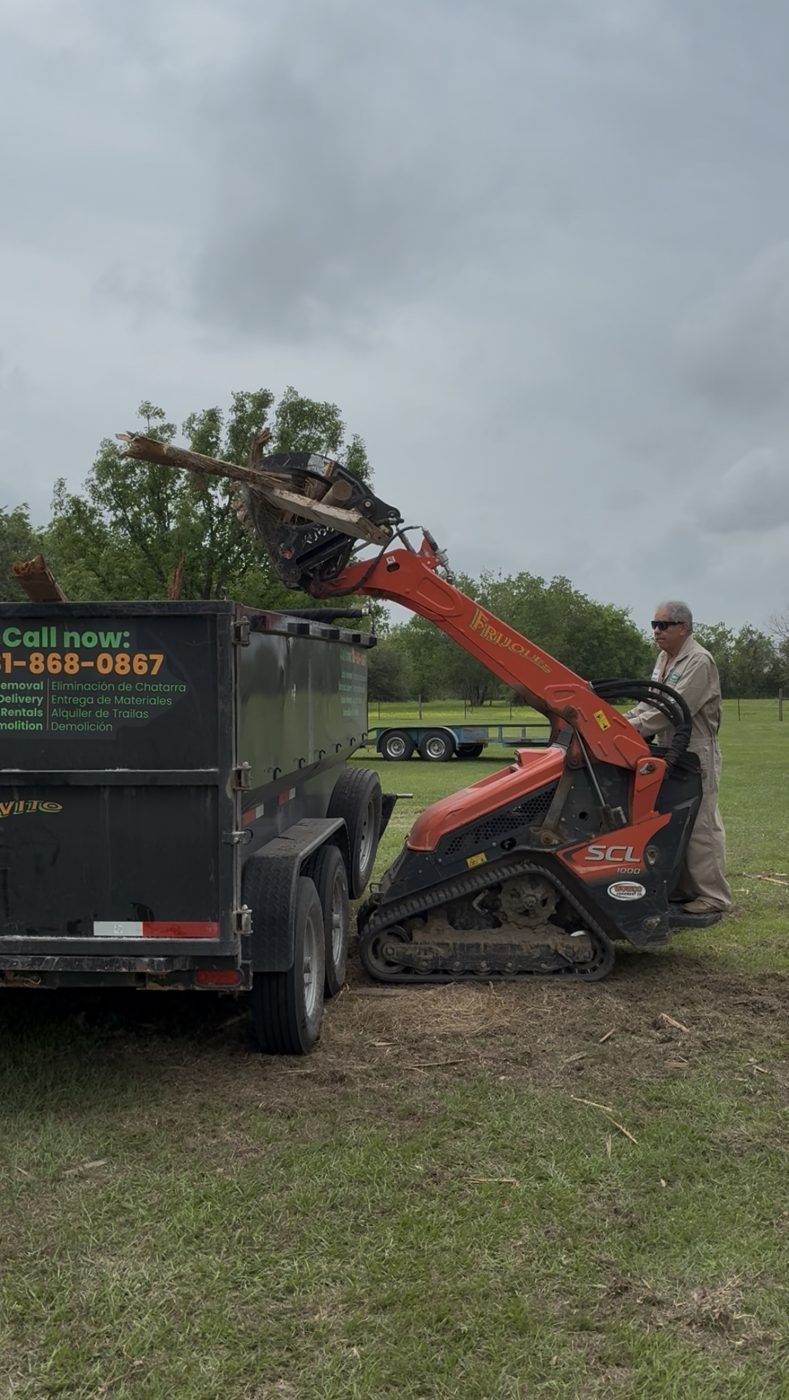 Kubota SCL1000 loading a Long Boy dump trailer
