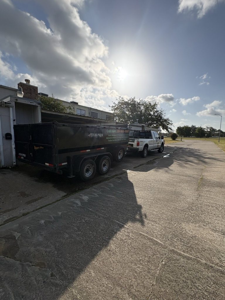 Long Boy dump trailer and truck in a residential driveway