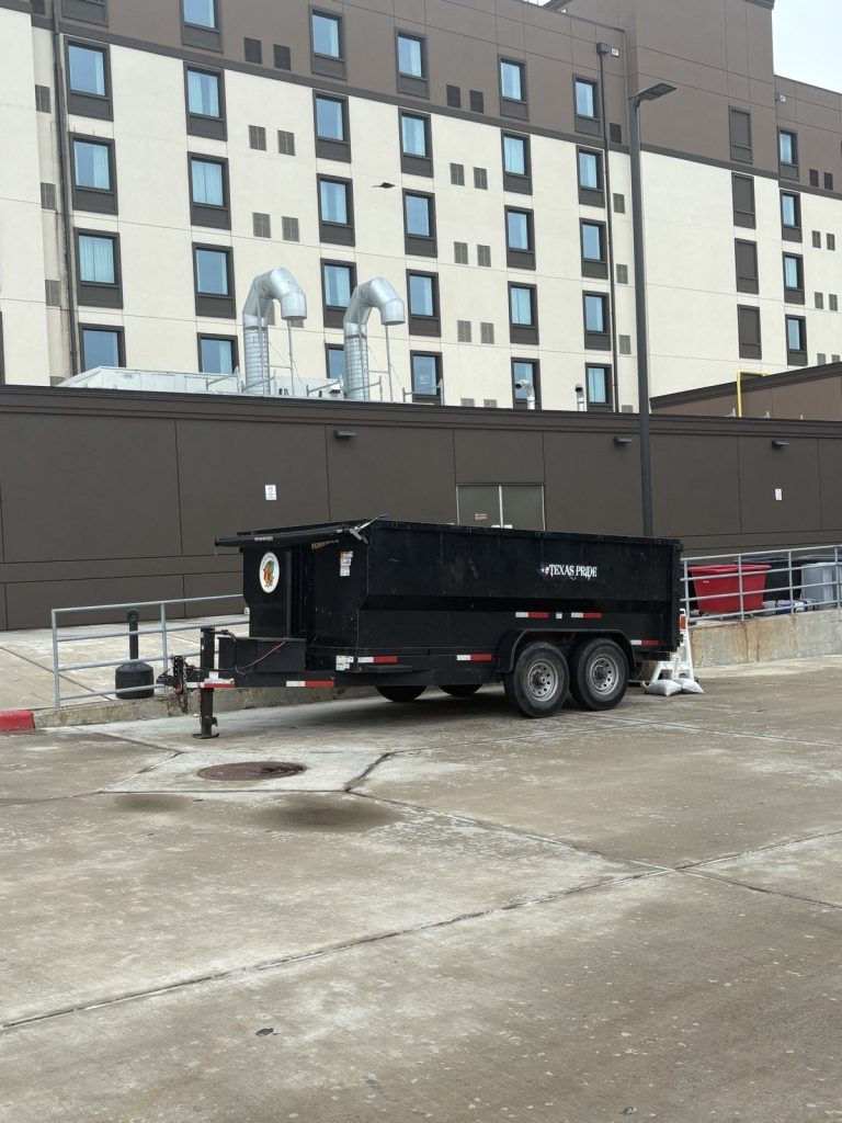 Long Boy dump trailer, side view, at a commercial drop-off